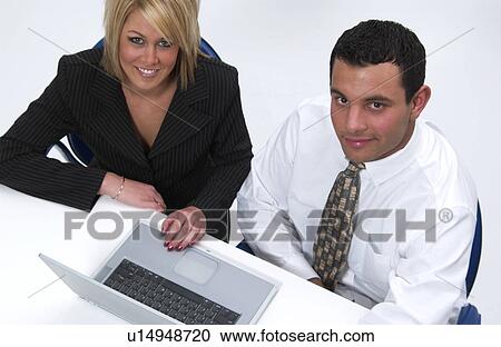 Man and woman working on laptop computer View Large Photo Image Stock Image - Man and woman working on laptop computer. Fotosearch