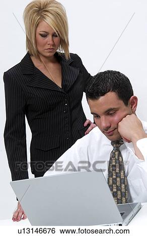 Stock Photograph - Man and woman working on laptop computer. Fotosearch