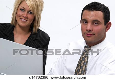 Man and woman working on laptop computer View Large Photo Image Stock Photograph - Man and woman working on laptop computer. Fotosearch