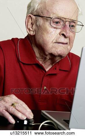 Stock Image - Man working on computer. Fotosearch