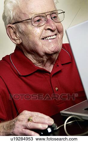 Stock Image - Man working on computer. Fotosearch