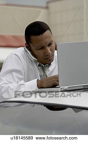 Man working on laptop View Large Photo Image Stock Photo - Man working on laptop. Fotosearch