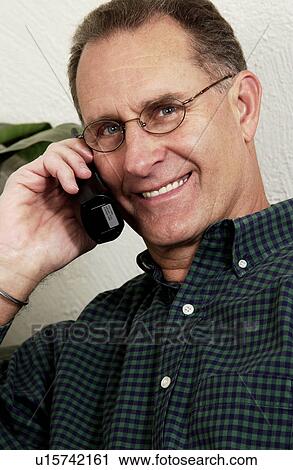 Stock Image - Older man talking on phone. Fotosearch