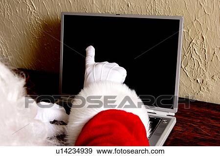 Santa with laptop View Large Photo Image Stock Photo - Santa with laptop. Fotosearch