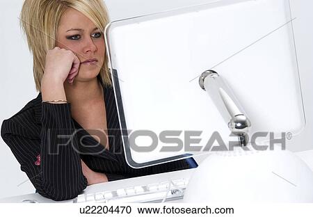 Stock Image - Woman working at computer. Fotosearch