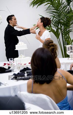 Bride and groom cutting cake View Large Photo Image Stock Photography - Bride and groom cutting cake. Fotosearch