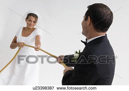 Bride and groom playing tug of war View Large Photo Image Stock Photo - Bride and groom playing tug of war. Fotosearch