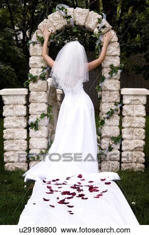 Stock Image - Bride throwing her bouquet. Fotosearch