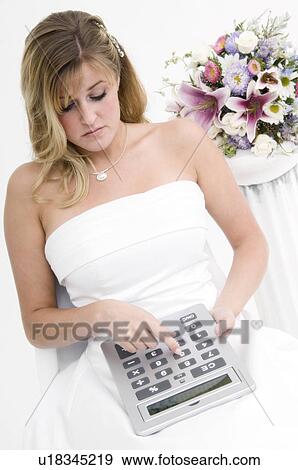 Stock Photo - Bride using calculator. Fotosearch