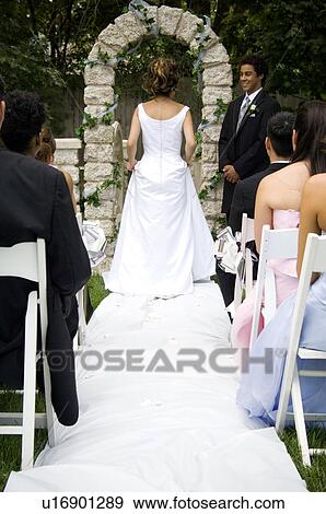 Stock Photo - Bride walking down aisle. Fotosearch