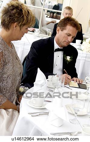 Bride's father writing check View Large Photo Image Picture - Bride's father writing check. Fotosearch