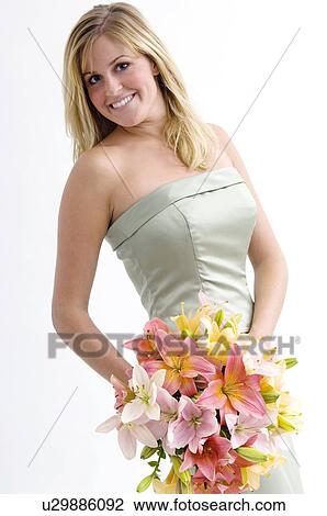Stock Image - Bridesmaid holding bouquet. Fotosearch