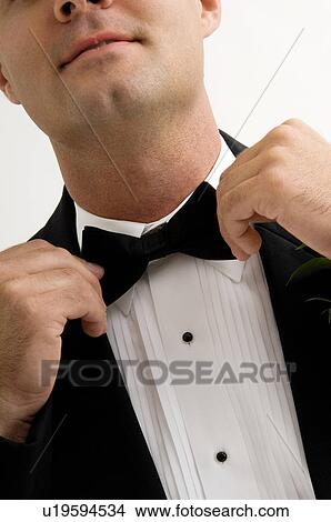 Picture - Man fixing bow tie. Fotosearch