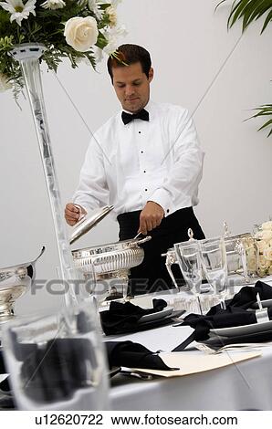 Stock Image - Server preparing food. Fotosearch