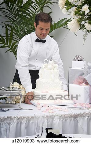 Server setting wedding cake on table View Large Photo Image Stock Image - Server setting wedding cake on table. Fotosearch