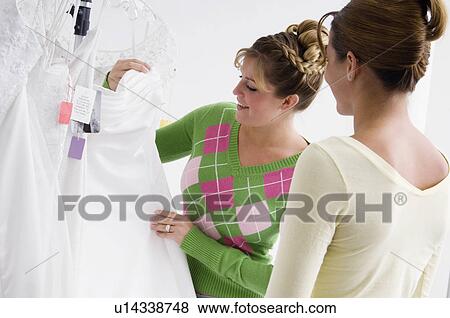 Woman choosing bridal gown View Large Photo Image Stock Photo - Woman choosing bridal gown. Fotosearch