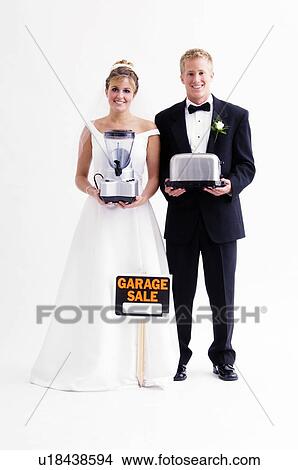 Picture - Bride and groom holding gifts. Fotosearch
