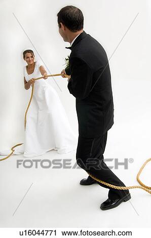 Bride and groom playing tug of war View Large Photo Image Stock Image - Bride and groom playing tug of war. Fotosearch