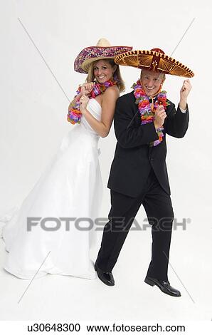 Bride and groom wearing sombreros and flower leis while dancing View Large Photo Image Stock Image - Bride and groom wearing sombreros and flower leis while dancing. Fotosearch