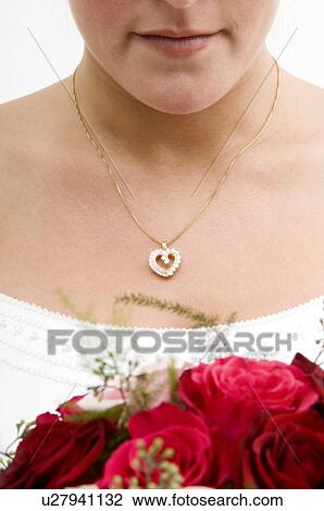 Stock Image - Bride holding bridal bouquet. Fotosearch