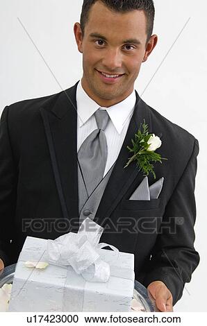 Groom with gift on silver platter View Large Photo Image Stock Image - Groom with gift on silver platter. Fotosearch