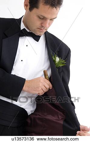 Man putting cigar inside his suit jacket View Large Photo Image Stock Photograph - Man putting cigar inside his suit jacket. Fotosearch