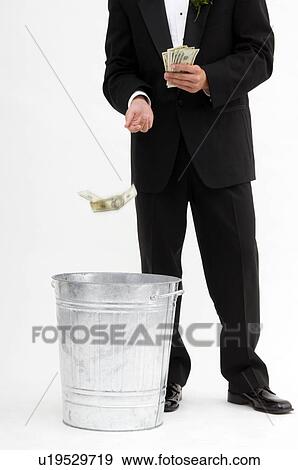 Man throwing away money View Large Photo Image Stock Photo - Man throwing away money. Fotosearch