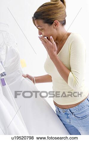 Woman choosing a bridal gown View Large Photo Image Stock Photo - Woman choosing a bridal gown. Fotosearch