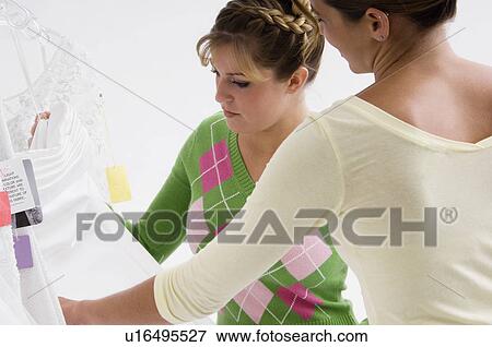 Woman choosing bridal gown View Large Photo Image Stock Photo - Woman choosing bridal gown. Fotosearch