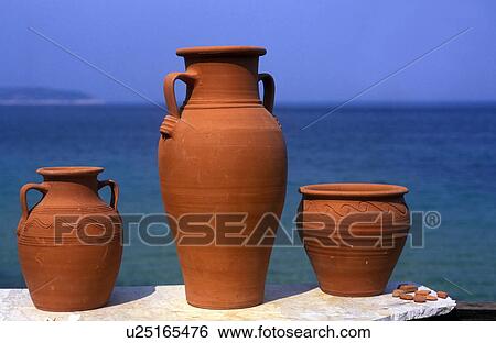 Stock Photograph - Pottery on a wall in front of sea. Fotosearch