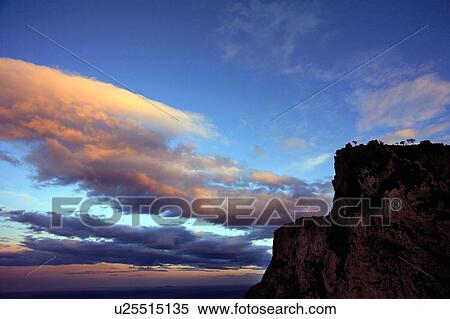 Stock Photography - Cliffside with sunset sky. Fotosearch