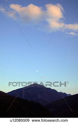 Mountain tops in the sky View Large Photo Image Stock Photo - Mountain tops in the sky. Fotosearch