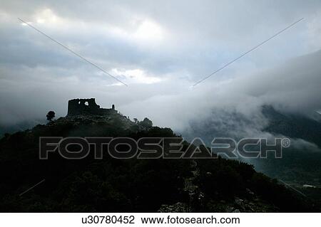 Stock Image - Stone ruin on a cloudy mountaintop. Fotosearch