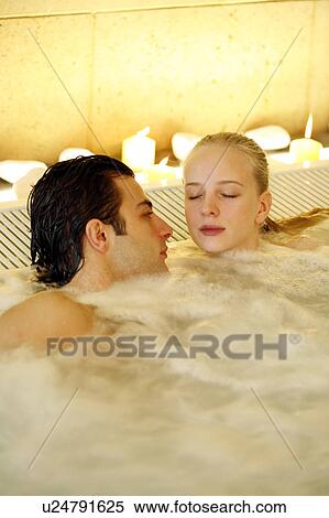 Stock Photography - Couple in jacuzzi at a spa. Fotosearch