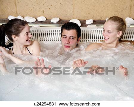 One man with two women in jacuzzi at a spa View Large Photo Image Stock Image - One man with two women in jacuzzi at a spa. Fotosearch