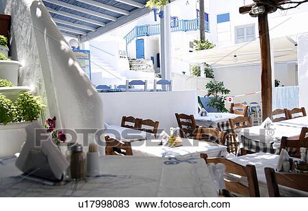 Stock Image - Tables set at restaurant. Fotosearch
