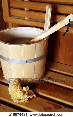 Stock Image - Water bucket with ladle in a sauna. Fotosearch
