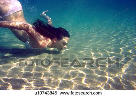Woman diving under the water View Large Photo Image Stock Photography - Woman diving under the water. Fotosearch