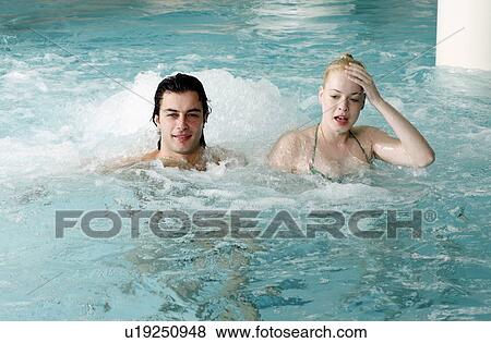 Young couple swimming in spa pool View Large Photo Image Stock Photo - Young couple swimming in spa pool. Fotosearch