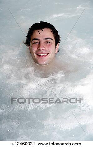 Stock Image - Young man in jacuzzi at a spa. Fotosearch