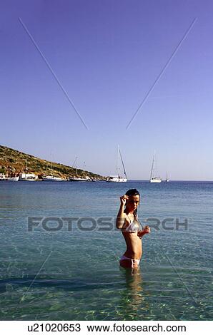 Young woman at the beach in water View Large Photo Image Stock Image - Young woman at the beach in water. Fotosearch