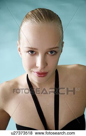 Stock Photo - Young woman in a swimming pool at a spa. Fotosearch