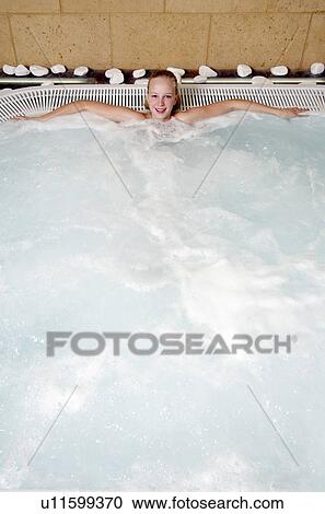 Young woman in jacuzzi at a spa View Large Photo Image Stock Image - Young woman in jacuzzi at a spa. Fotosearch