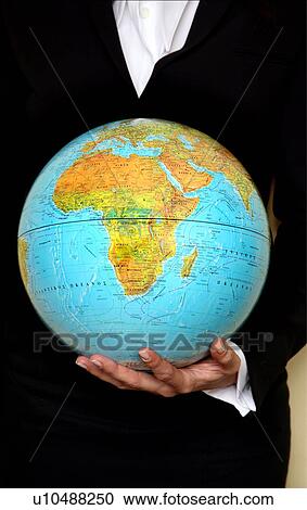 Stock Image - A woman holding a globe . Fotosearch