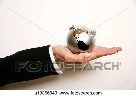 Stock Photo - A woman holding a globe . Fotosearch
