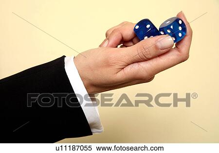 A woman holding a pair of blue dice View Large Photo Image Stock Photography - A woman holding a pair of blue dice . Fotosearch