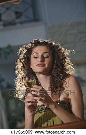 A woman in a bar drinking wine View Large Photo Image Stock Photo - A woman in a bar drinking wine. Fotosearch