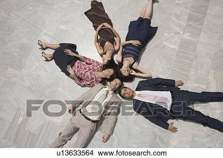 Business people lying on the ground View Large Photo Image Picture - Business people lying on the ground. Fotosearch