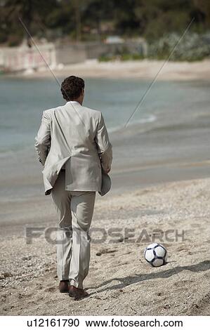 Businessman on beach playing soccer View Large Photo Image Stock Image - Businessman on beach playing soccer. Fotosearch