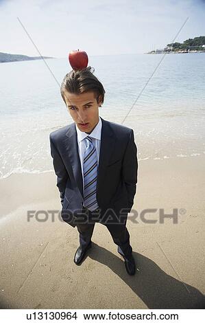 Businessman with apple balanced on his head View Large Photo Image Picture - Businessman with apple balanced on his head. Fotosearch